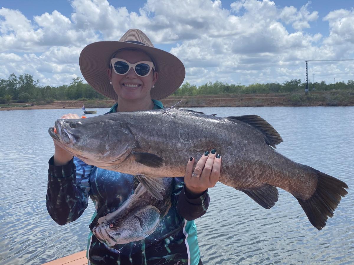 Lady holding up Bonus Charity Fish