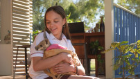 Lily Whiteley on the set of KANGAROO with an orphaned joey
