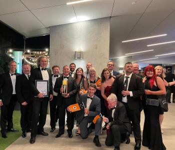 image of men and women dressed in suits and gowns at awards night