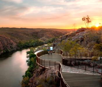 A couple stand and watch the sunset on a platform overlooking Katherine Gorge, Nitmiluk National Park