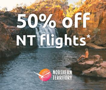text of 50% off NT flights on top of image of waterfall with woman on rock