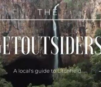 image of white text that reads THE GET OUTSIDERS on top of image of waterfall
