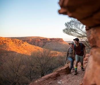 image of woman and man hiking with rocks