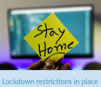 image of hand holding post it note with text Stay Home