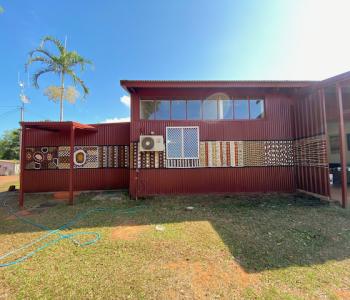 exterior of building with a mural featuring aboriginal design