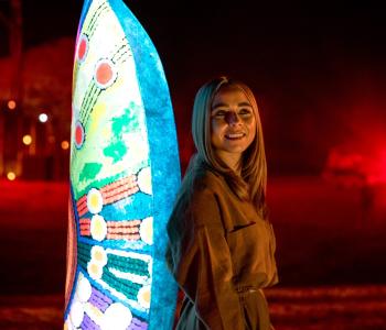 woman standing against a light installation