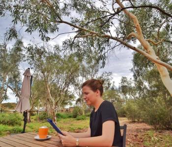 Sitting Down Reading an iPad in Alice Springs