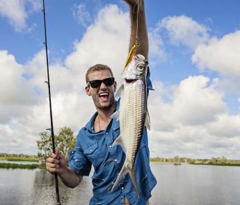 Man holding fish that he caught