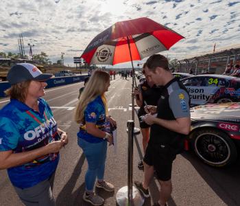 Supercar driver signing autographs