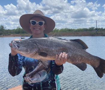 Lady holding up Bonus Charity Fish