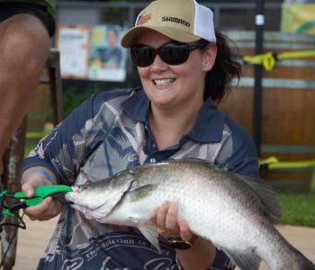 Woman holding a barra she has caught