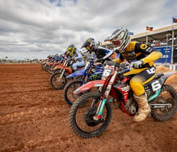 Motorcross competitors line up as the race begins