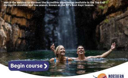 couple swimming under a waterfall